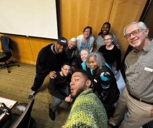 Facilitator Geoffrey and his cohort posing as a group for a selfie 